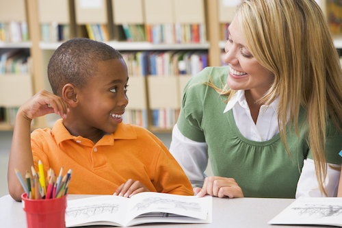 teacher and boy reading